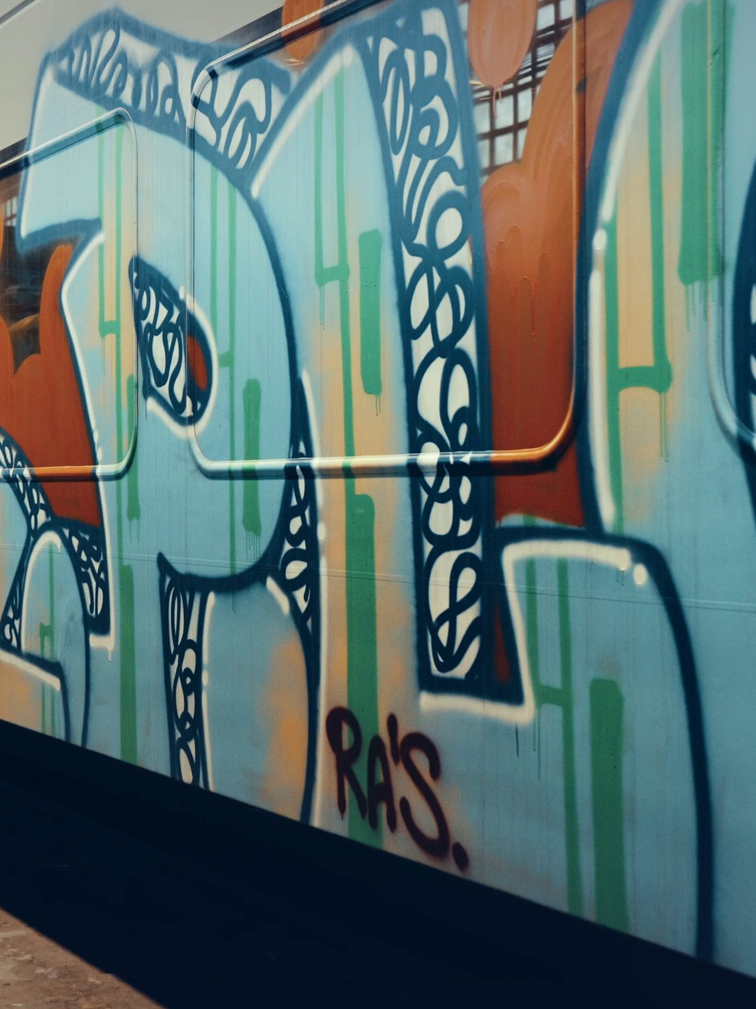 A railcar covered end to end in a graffiti piece