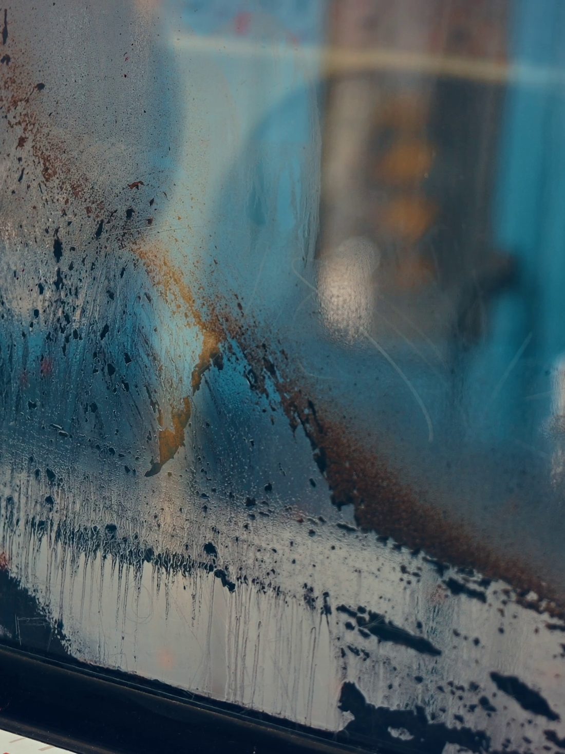 A weathered, stained vehicle surface before treatment